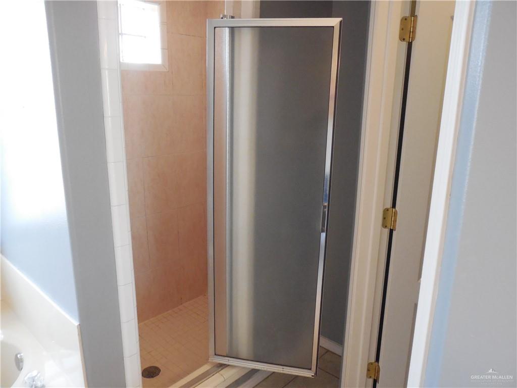 bathroom with a shower with door