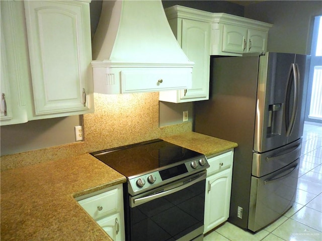 kitchen with white cabinets, stainless steel appliances, and custom exhaust hood