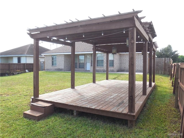 deck featuring a pergola and a lawn