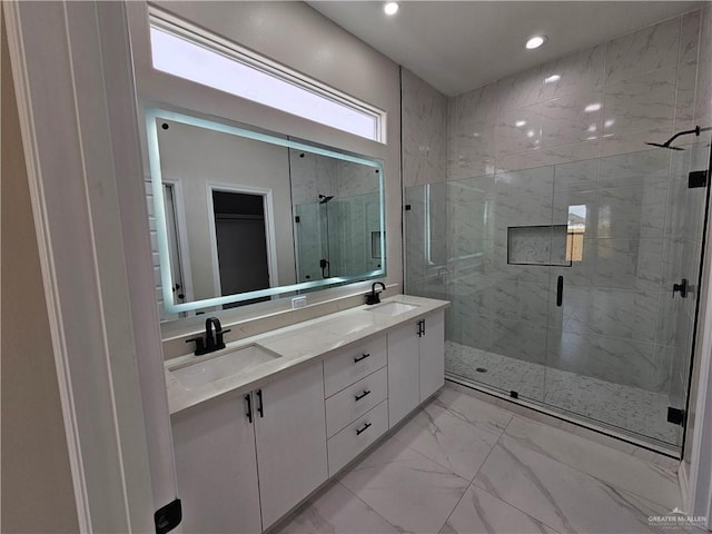 bathroom featuring vanity and a shower with door