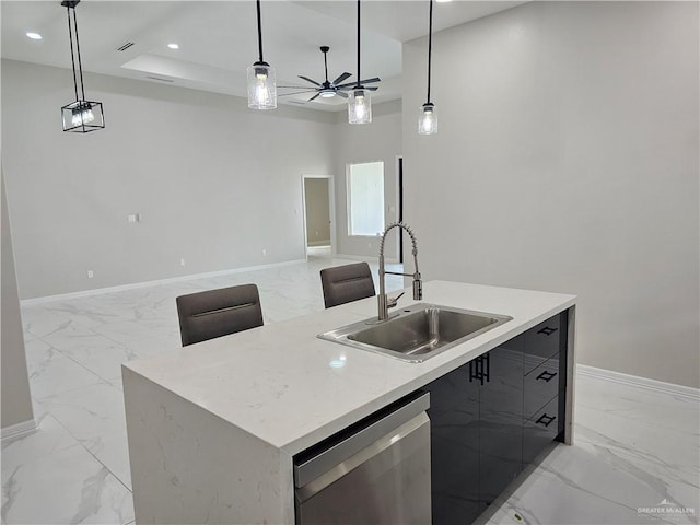 kitchen with sink, stainless steel dishwasher, and pendant lighting