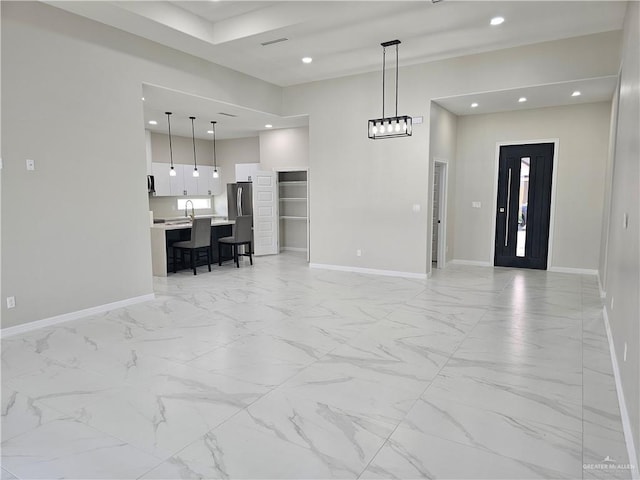 unfurnished living room with sink