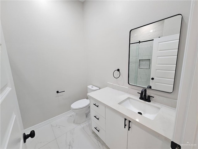 bathroom featuring vanity, an enclosed shower, and toilet