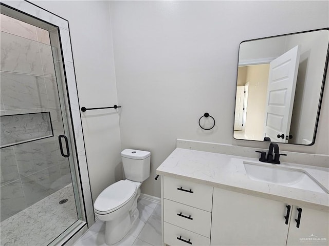 bathroom with vanity, toilet, and a shower with shower door