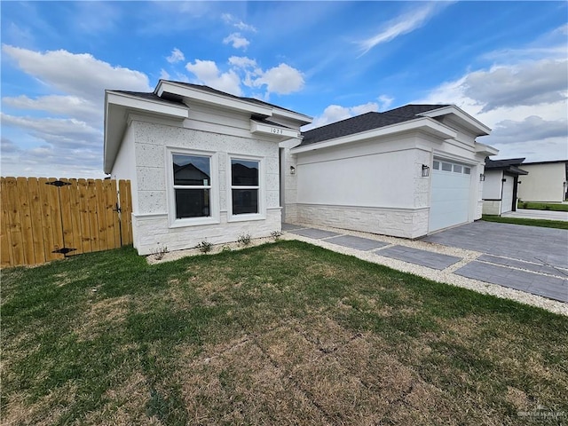 view of property exterior with a garage and a yard