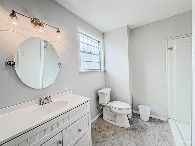 bathroom featuring tile patterned floors, vanity, and toilet