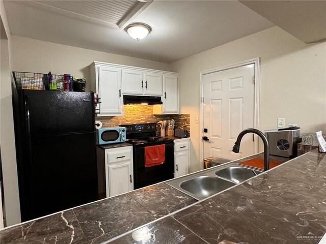 9216 N 31st St, Mcallen, TX 78504 - kitchen with black appliances, under cabinet range hood, white cabinets, and decorative backsplash