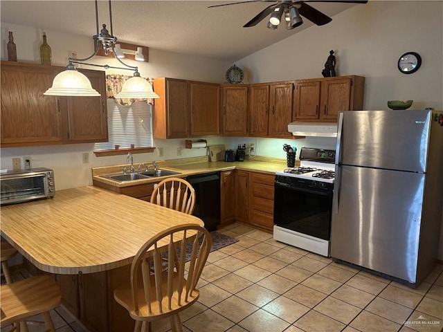 kitchen with sink, white gas range oven, hanging light fixtures, stainless steel fridge, and black dishwasher