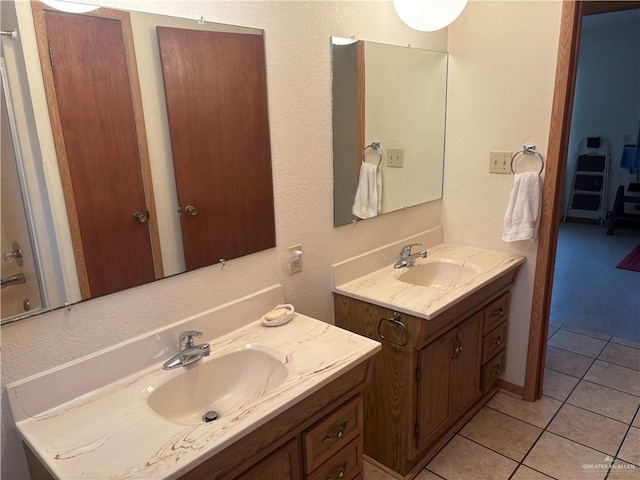 bathroom with tile patterned flooring and vanity