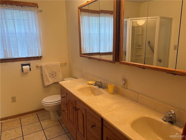 bathroom featuring tile patterned flooring, vanity, a healthy amount of sunlight, and an enclosed shower