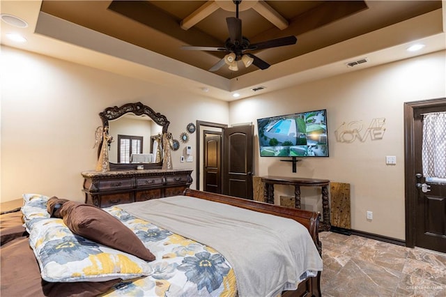 bedroom with a raised ceiling and ceiling fan