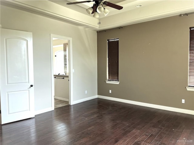 unfurnished bedroom featuring ceiling fan and dark hardwood / wood-style floors