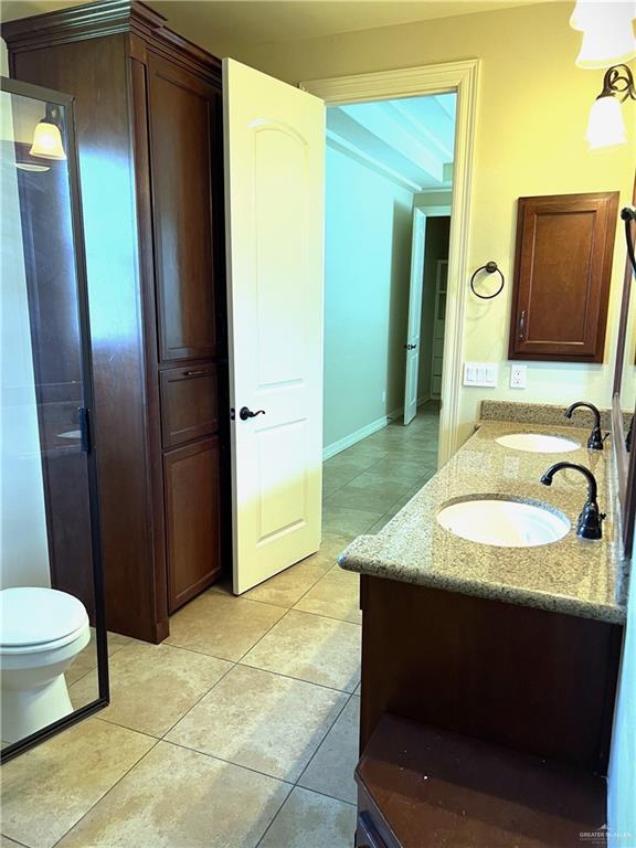 bathroom with tile patterned floors, vanity, and toilet