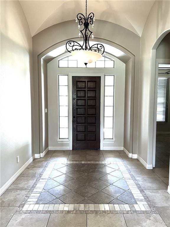 entrance foyer with lofted ceiling and a chandelier