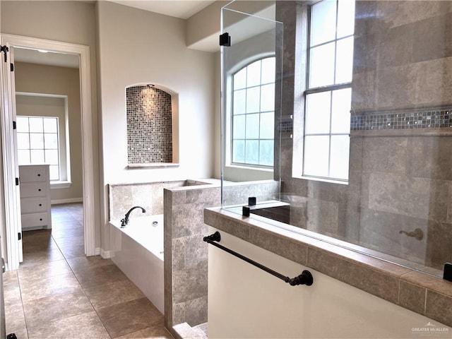 bathroom with tile patterned flooring and independent shower and bath