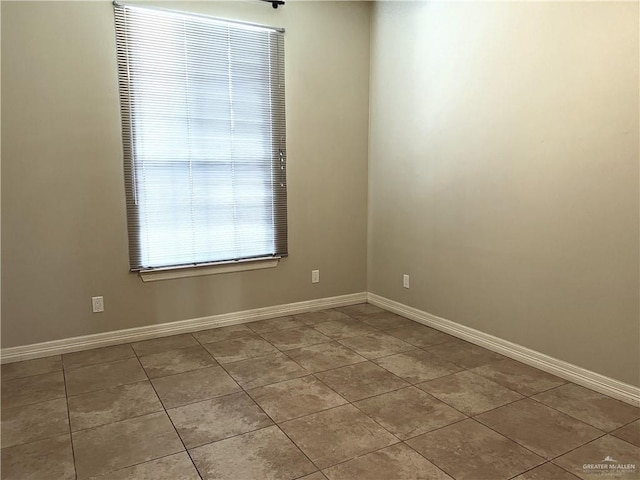 spare room featuring light tile patterned flooring