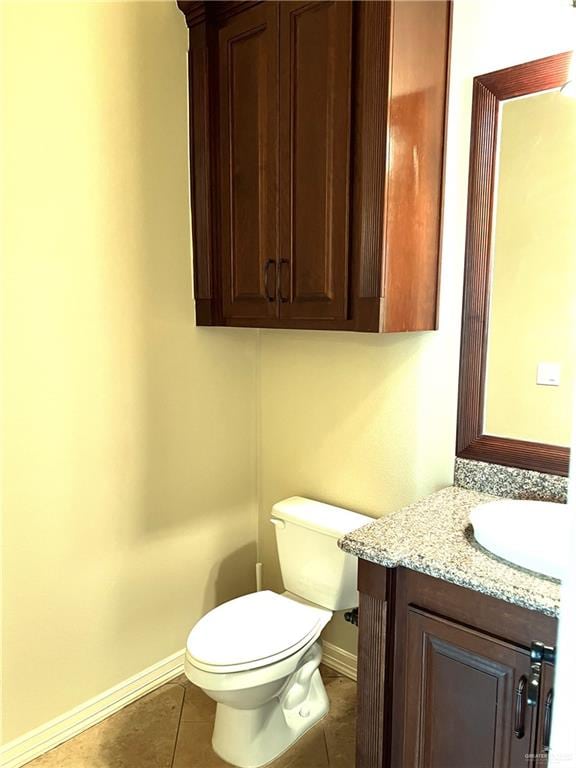 bathroom with tile patterned floors, vanity, and toilet