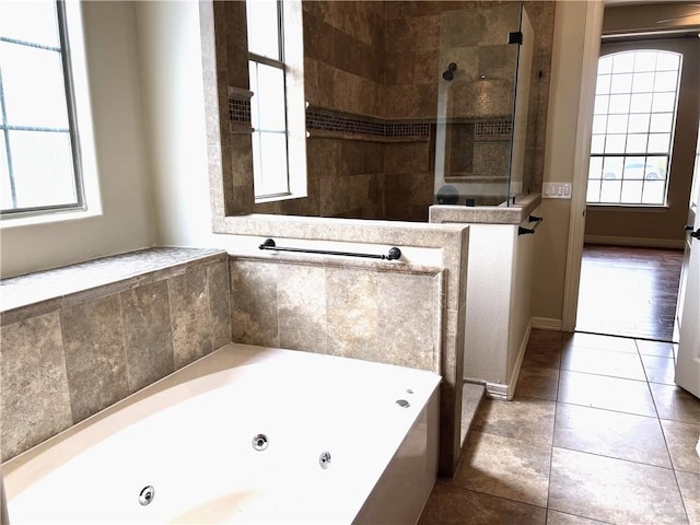 bathroom featuring tile patterned floors and separate shower and tub