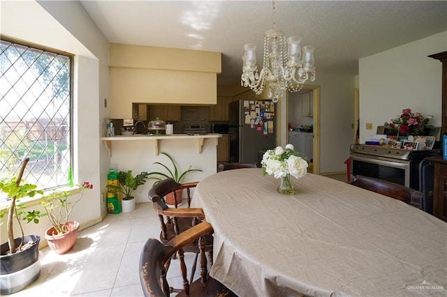 603 S Alamo Rd, Alamo, TX 78516 - dining area featuring an inviting chandelier, baseboards, tile patterned flooring, and a healthy amount of sunlight