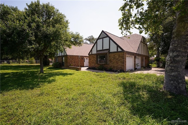 603 S Alamo Rd, Alamo, TX 78516 - view of side of home with a lawn, brick siding, and roof with shingles