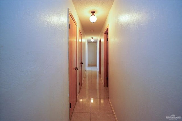 603 S Alamo Rd, Alamo, TX 78516 - corridor featuring light tile patterned floors, baseboards, and a textured wall