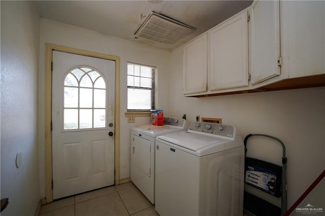 603 S Alamo Rd, Alamo, TX 78516 - washroom with cabinet space, light tile patterned floors, visible vents, and washer and clothes dryer