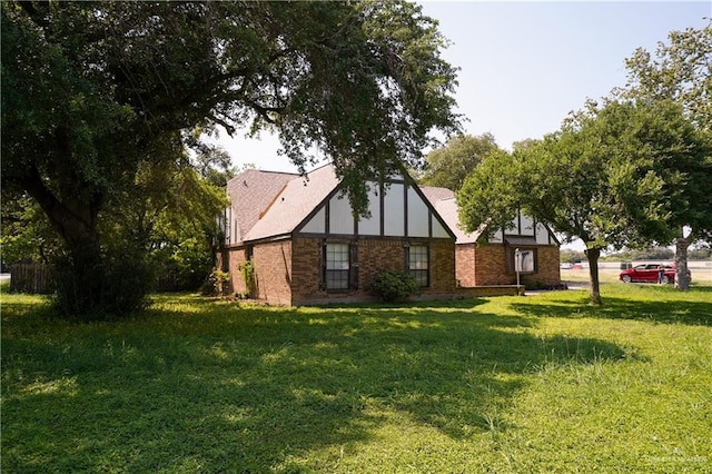 603 S Alamo Rd, Alamo, TX 78516 - view of home's exterior featuring a lawn and brick siding