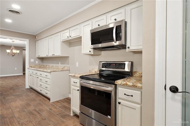 524 Palm Valley Dr E, Harlingen, TX 78552 - kitchen with stainless steel appliances, ornamental molding, wood finished floors, light stone counters, and baseboards