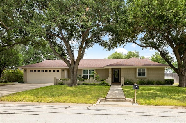 524 Palm Valley Dr E, Harlingen, TX 78552 - ranch-style house featuring an attached garage, concrete driveway, and brick siding