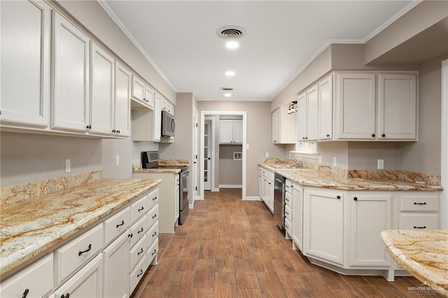 524 Palm Valley Dr E, Harlingen, TX 78552 - kitchen featuring appliances with stainless steel finishes, a sink, crown molding, light stone countertops, and wood finished floors
