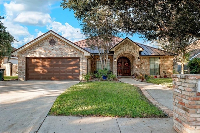 view of front facade with a front yard and a garage