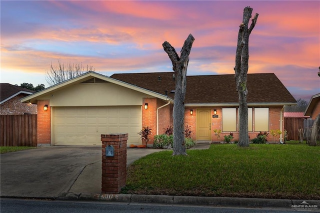 single story home with a garage and a yard