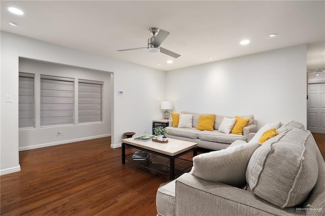 living room with ceiling fan and dark hardwood / wood-style floors