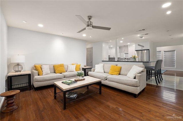 living room with dark hardwood / wood-style floors and ceiling fan