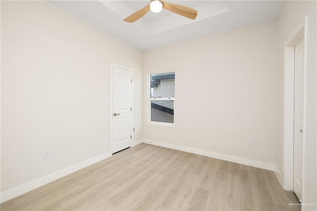 2510 E Solar Dr, Mission, TX 78574 - unfurnished bedroom with light wood-type flooring, a raised ceiling, and a ceiling fan