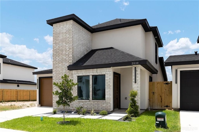 2510 E Solar Dr, Mission, TX 78574 - contemporary home with concrete driveway, brick siding, an attached garage, roof with shingles, and a chimney