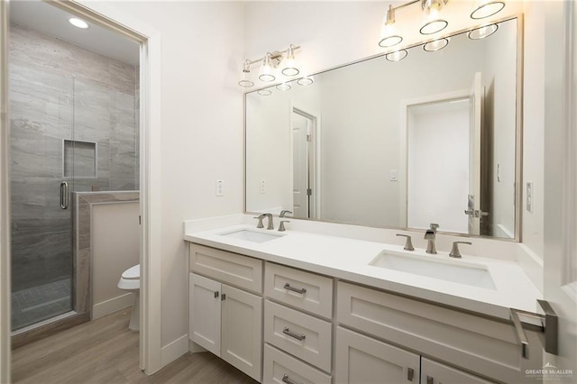2510 E Solar Dr, Mission, TX 78574 - full bath featuring double vanity, a shower stall, wood finished floors, and recessed lighting