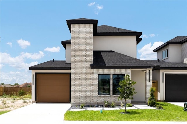 2510 E Solar Dr, Mission, TX 78574 - modern home featuring concrete driveway, an attached garage, a shingled roof, and a chimney