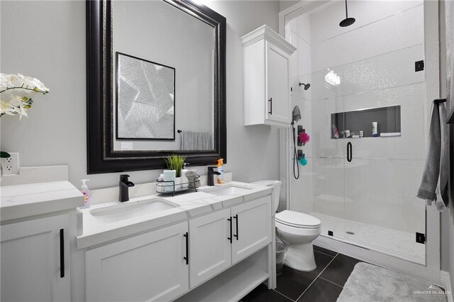 102 E Whiting St Unit A & B, South Padre Island, TX 78597 - bathroom featuring a shower stall, toilet, double vanity, and tile patterned flooring