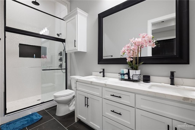 102 E Whiting St Unit A & B, South Padre Island, TX 78597 - bathroom featuring toilet, a shower stall, double vanity, and tile patterned floors