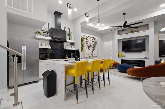 102 E Whiting St Unit A & B, South Padre Island, TX 78597 - kitchen with stainless steel appliances, open shelves, ceiling fan, backsplash, and an island with sink