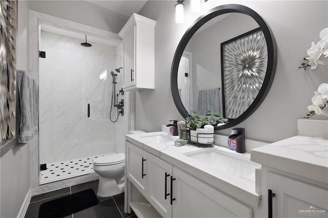 102 E Whiting St Unit A & B, South Padre Island, TX 78597 - bathroom featuring double vanity, a marble finish shower, toilet, and tile patterned flooring