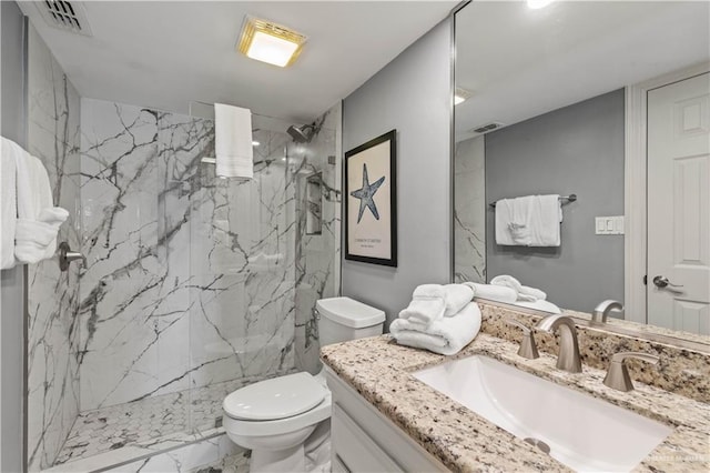 bathroom featuring marble finish floor, visible vents, toilet, vanity, and a marble finish shower