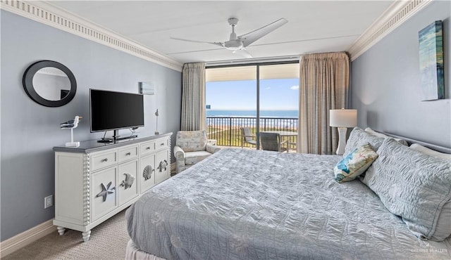 carpeted bedroom with crown molding, ceiling fan, a wall of windows, baseboards, and access to exterior