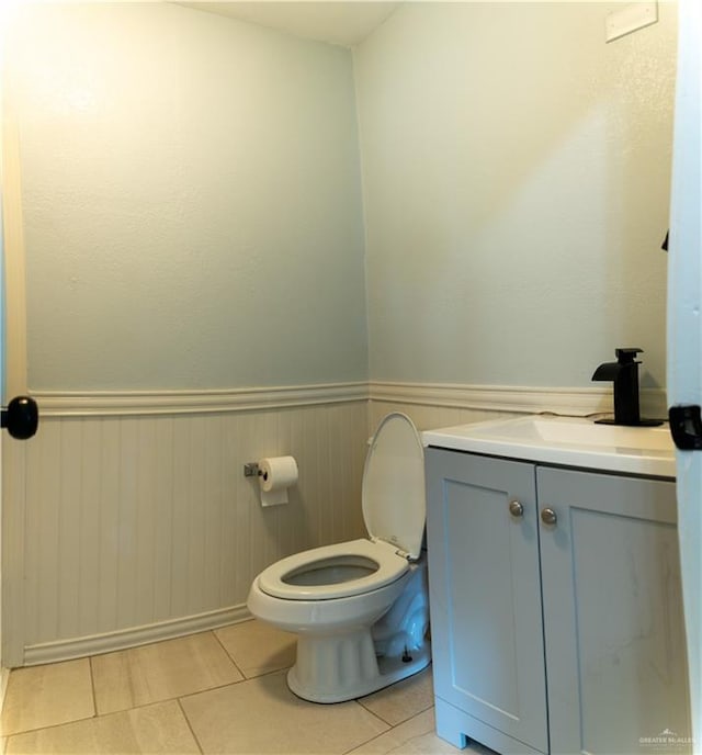 bathroom featuring tile patterned flooring, vanity, and toilet