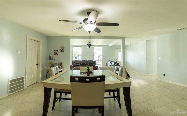 tiled dining area featuring ceiling fan