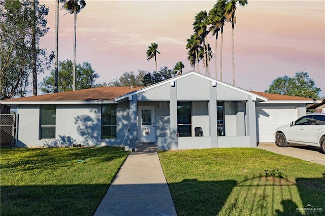 view of front facade with a yard and a garage