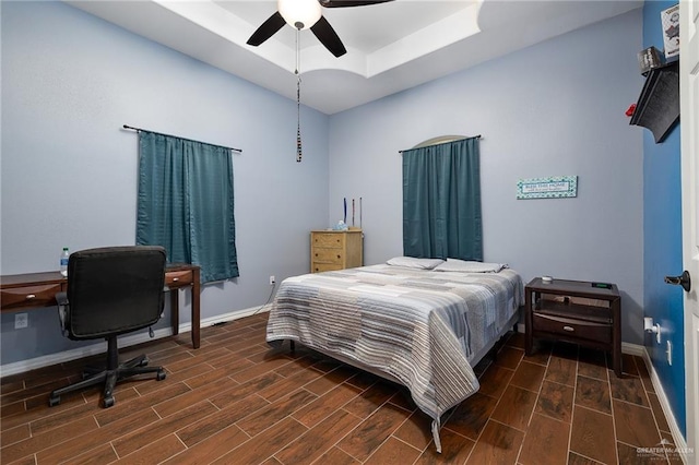 bedroom with baseboards, a ceiling fan, and wood finish floors