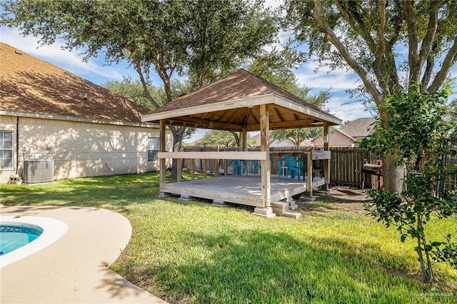 view of yard featuring central AC, a gazebo, and fence