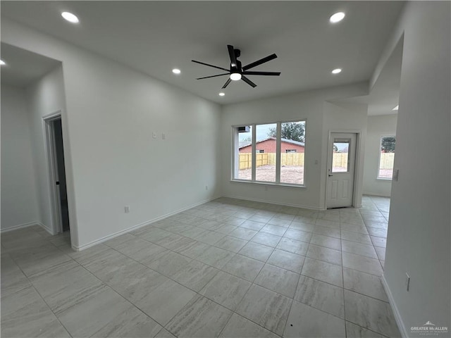 unfurnished room with light tile patterned floors and ceiling fan